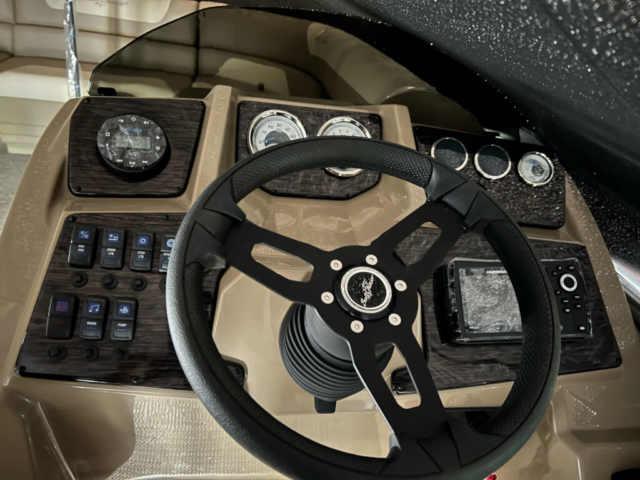 Helm of the 2023 SunChaser Geneva, showing the steering wheel, gauges, and controls