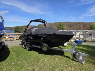 boat on trailer covered with black canvas