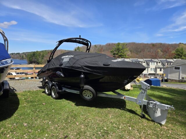 boat on trailer covered with black canvas