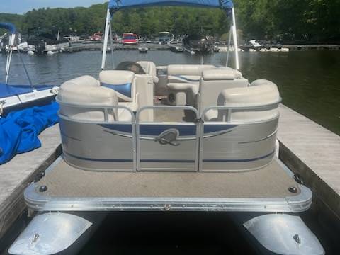 exterior front. boat is silver and blue on outside